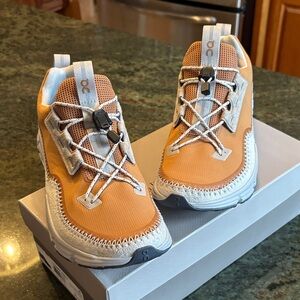 On Running Burnt Orange and White Sneakers